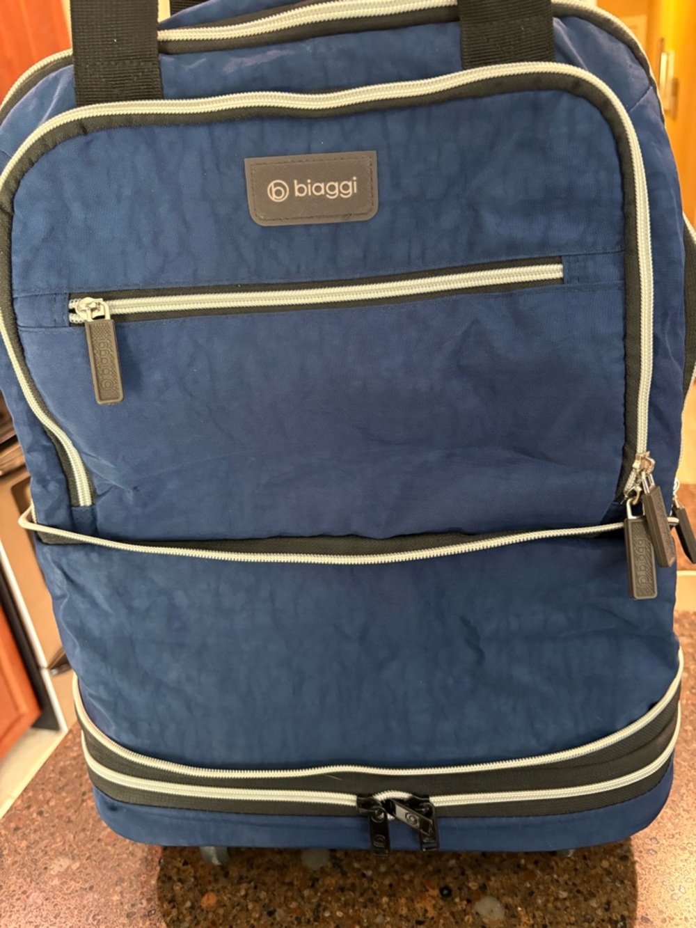 Biaggi Blue Rolling Travel Bag with Zip Pockets and free zip cube